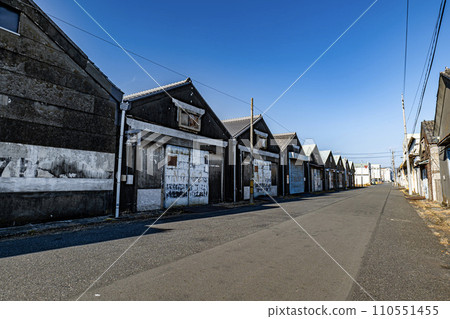 A road lined with retro warehouses 110551455