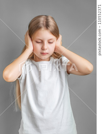 Little girl holding her head. 110552371