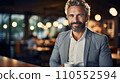 Entrepreneur in his 50s seated in a cozy cafe, holding a cup of espresso. Generative AI Fictional person. 110552594