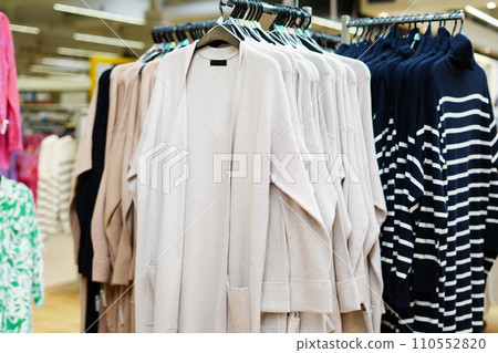 Stylish clothes on hangers in the store Stylish clothes on hangers in the store 110552820