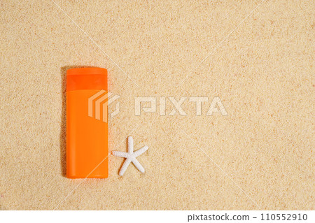Sunscreen in orange plastic tube with white starfish on sand background . Sunscreen with UVA and UVB protection. Summer, sea Sunscreen in orange plastic tube with white starfish on sand background . Sunscreen with UVA and UVB protection. Summer, sea 110552910