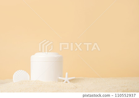 Cosmetic cream in white bottle with Starfish on the sand on yellow background, copy space. UVA and UVB protection. Summer cosmetics 110552937