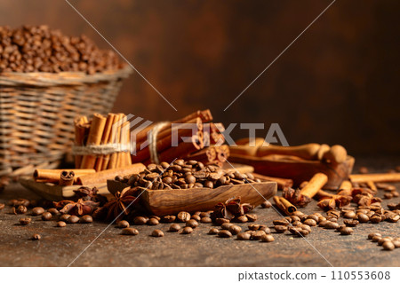 Coffee beans with spices on a brown vintage background. 110553608