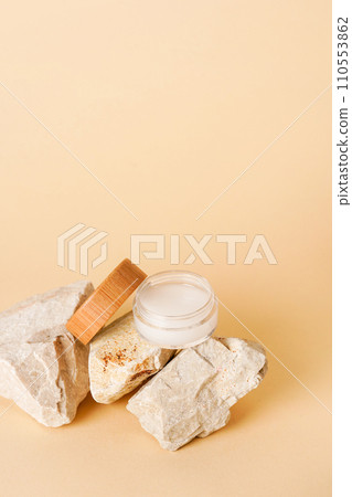 Cosmetic jar wooden lid with cream or lotion on stone podium for product presentation. Skincare cosmetic. yellow background. Beauty concept for face care Cosmetic jar wooden lid with cream or lotion on stone podium for product presentation. Skincare cosmetic. yellow background. Beauty concept for face care 110553862