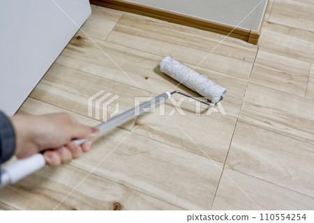 Clean up a lot of hair that has fallen on the floor with adhesive cleaner 110554254