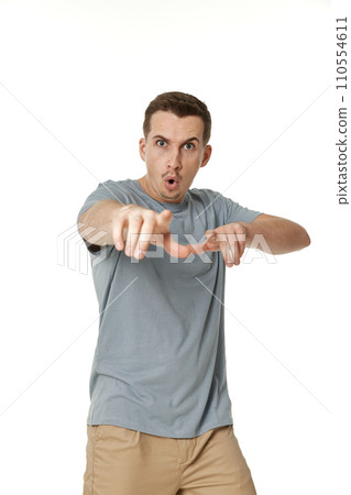 surprised guy pointing at the camera on white studio background surprised guy pointing at the camera on white studio background 110554611