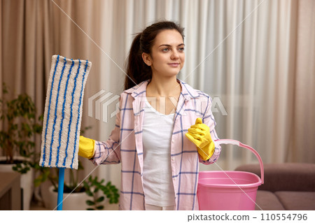 woman cleaning floor at living room, girl holding bucket and mop, daily housekeeping woman cleaning floor at living room, girl holding bucket and mop, daily housekeeping 110554796
