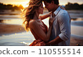 Ocean Love Affair: Young Couple in Beautiful Outfits Spinning and Hugging at Sunset 110555514