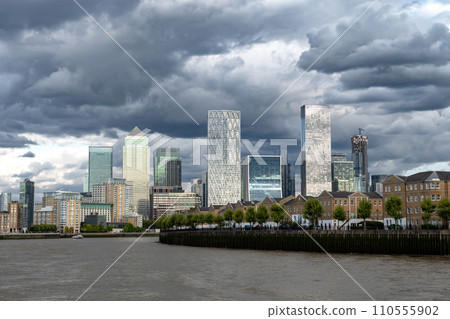 Modern Office Buildings, Skyscrapers And Luxury Apartment Buildings At Canary Wharf Beneath The River Thames In London, United Kingdom Modern Office Buildings, Skyscrapers And Luxury Apartment Buildings At Canary Wharf Beneath The River Thames In London, United Kingdom 110555902