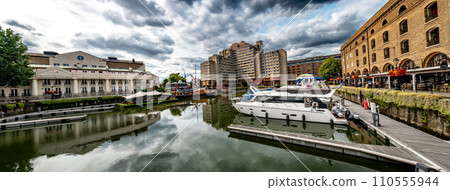Boats And Ships In St Katharine Docks With Office Buildings And Restaurants In London, United Kingdom Boats And Ships In St Katharine Docks With Office Buildings And Restaurants In London, United Kingdom 110555944
