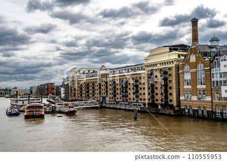 River Thames With Boats And Docks Beneath Butler's Wharf From Tower Bridge In London, United Kingdom 110555953