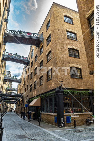 Shad Thames Buildings And Luxury Apartments With Cobblestone Alley Near Tower Bridge In London, United Kingdom Shad Thames Buildings And Luxury Apartments With Cobblestone Alley Near Tower Bridge In London, United Kingdom 110555999