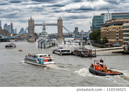 River Thames With Tower Bridge And Warship Belfast In Front Of London Skyline With Modern Skyscrapers In The United Kingdom 110556025