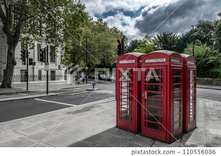 Red Public Phone Boxes In The Streets Of The City Of London In Front Of Kensington Garden In Great Britain Red Public Phone Boxes In The Streets Of The City Of London In Front Of Kensington Garden In Great Britain 110556086