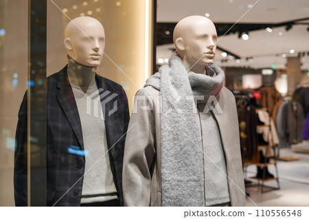 Male mannequins in a shop. Sale of clothes , suit , sweaters for men Male mannequins in a shop. Sale of clothes , suit , sweaters for men 110556548