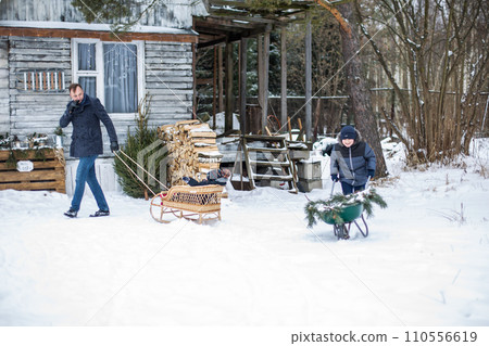 A father takes his son for a ride in the woods in winter A father takes his son for a ride in the woods in winter 110556619