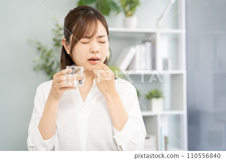 Woman taking medicine 110556840