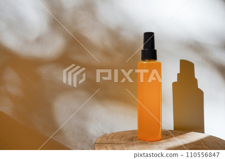 Essential oil on the wood on light background with shadows. Skin care cosmetic, Beauty concept for face body care Essential oil on the wood on light background with shadows. Skin care cosmetic, Beauty concept for face body care 110556847