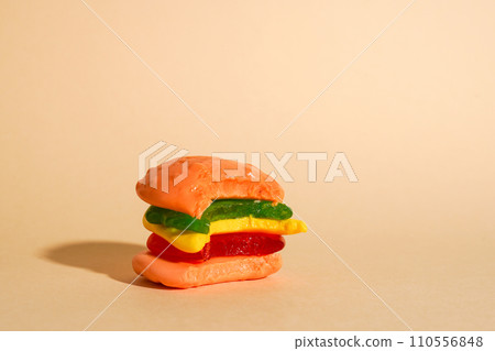 candy bitten off hamburger on yellow background with copy space candy bitten off hamburger on yellow background with copy space 110556848