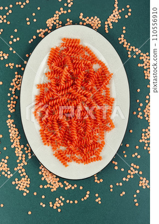 Raw orange spiral noodles. Raw orange spiral noodles. 110556910