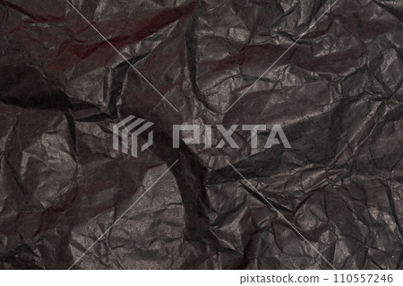 Black crumpled paper texture in low light background 110557246