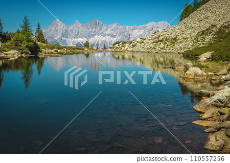 Picturesque mountain lake and high mountain ridges in Austria 110557256
