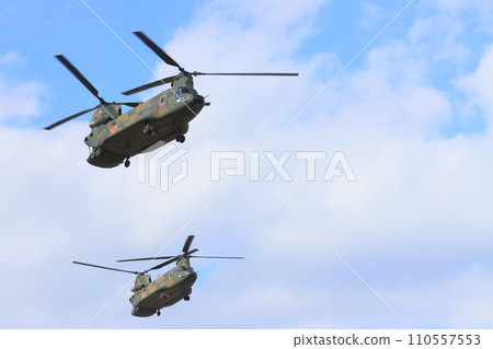 Large helicopter flying in two formations Large helicopter flying in two formations 110557553