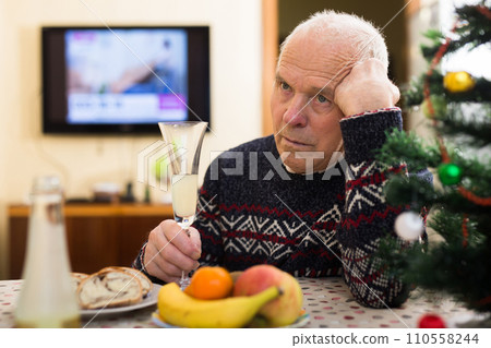 Sad older man celebrating New Year alone during pandemic Sad older man celebrating New Year alone during pandemic 110558244