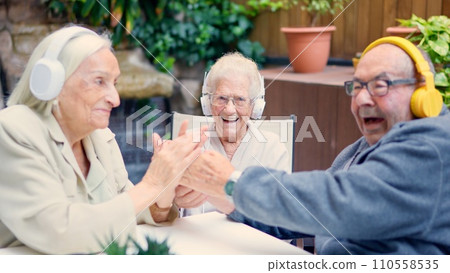 Senior people celebrating and greeting together in a geriatric Senior people celebrating and greeting together in a geriatric 110558535