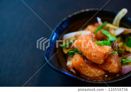 Spicy Salmon Salad on black background, Thai food 110558736