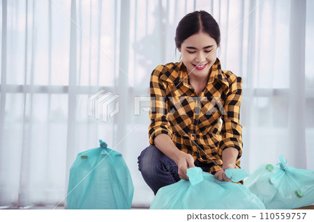 Women sort plastic bottle and tie plastic bag to reuse and recycling for conservation environment Women sort plastic bottle and tie plastic bag to reuse and recycling for conservation environment 110559757