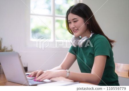 Young asian student women use technology laptop to typing communication through video chat in online class while studying and watching lecture webinar to learning knowledge remote education from home 110559779