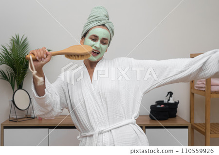 Home Spa Party: In her bathrobe, she sports a clay mask, using a hairbrush as a mic, dancing with a towel on her head, having a fabulous time.  110559926