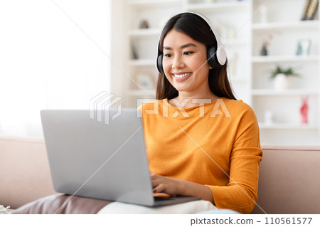 Happy young asian woman working from home Happy young asian woman working from home 110561577