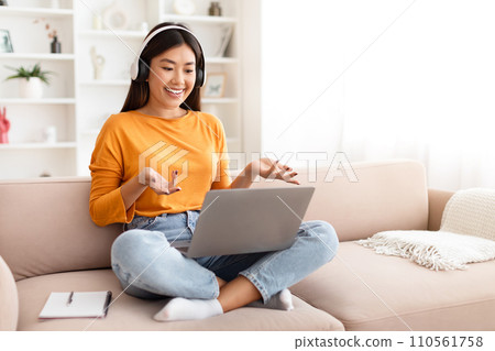 Young asian woman have online lesson, using laptop at home Young asian woman have online lesson, using laptop at home 110561758