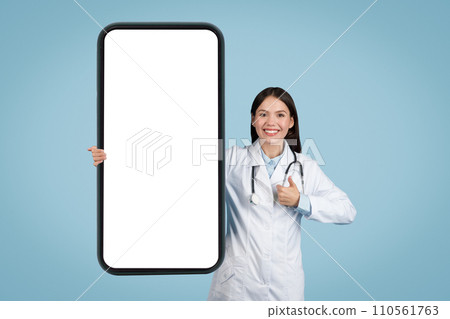 Doctor with thumbs up next to blank smartphone screen 110561763