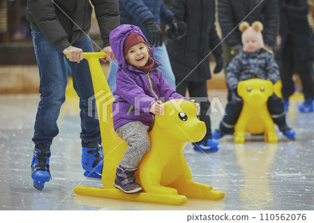 Charming child on an ice rink in Denmark 110562076