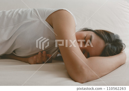 Woman fall asleep on the sofa as she tired and sick. Woman fall asleep on the sofa as she tired and sick. 110562263