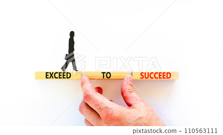Exceed to succeed symbol. Concept words Exceed to succeed on beautiful wooden blocks. Beautiful white table white background. Businessman hand. Business and exceed to succeed concept. Copy space. 110563111