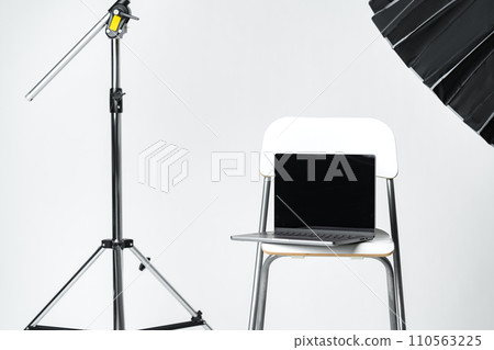 Laptop with black screen and photography equipment in photostudio Laptop with black screen and photography equipment in photostudio 110563225