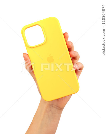 Berlin Germany December 21 2023 Yellow phone case in hand. Silicon protector isolated on white Berlin Germany December 21 2023 Yellow phone case in hand. Silicon protector isolated on white 110564074