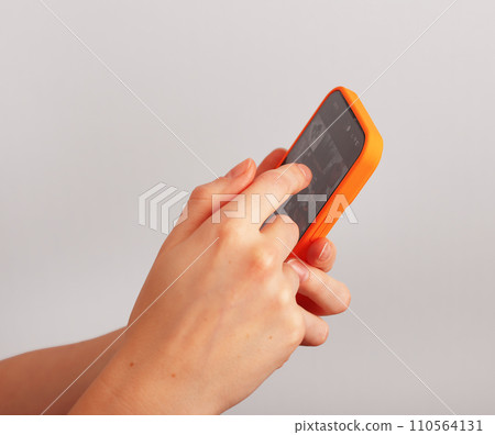 Hand holding mobile phone, smartphone, surfing internet, browsing online, scrolling social media Hand holding mobile phone, smartphone, surfing internet, browsing online, scrolling social media 110564131