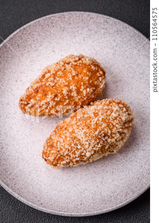 Delicious fresh cutlet or meatball Kiev style with filling Delicious fresh cutlet or meatball Kiev style with filling 110564575