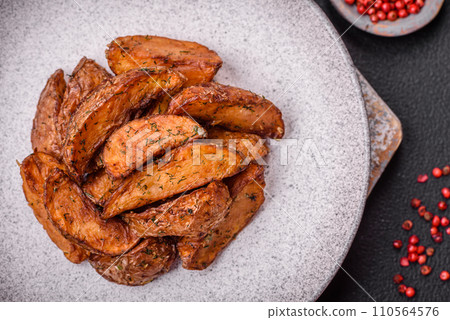 Delicious crispy potato wedges with garlic, salt, spices and herbs Delicious crispy potato wedges with garlic, salt, spices and herbs 110564576