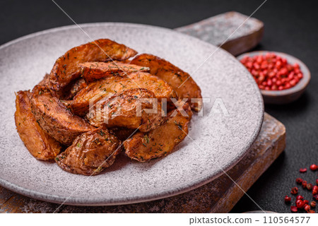 Delicious crispy potato wedges with garlic, salt, spices and herbs Delicious crispy potato wedges with garlic, salt, spices and herbs 110564577