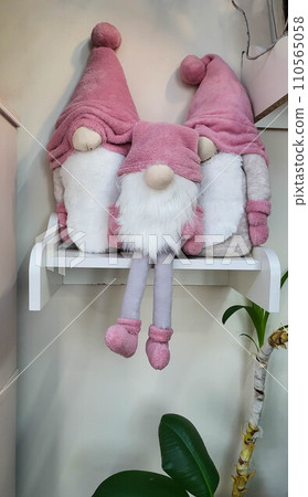 Three dwarfs are sitting on a wooden shelf. Christmas and New Year concept, greeting card 110565058