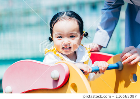 Family with kids, mom and cute girl playing in park 110565097
