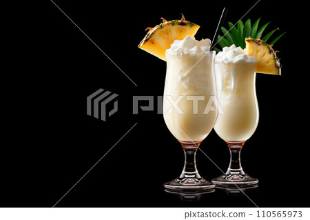 Set of Pina Colada with pineapple, coconut and creamy white top presented in a chilled glass with straw 110565973