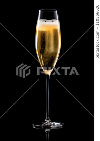 A crystal-clear flute glass of champagne isolated on black background 110566026