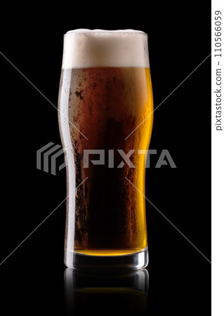 Beer in a tall glass on a dark black background. Mugs with drink like Ipa, Pale Ale, Pilsner, Porter or Stout Beer in a tall glass on a dark black background. Mugs with drink like Ipa, Pale Ale, Pilsner, Porter or Stout 110566059